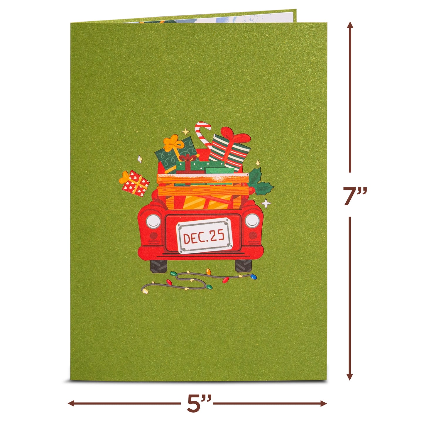 Green Christmas card cover with a red truck carrying gifts and a 'Dec. 25' license plate.