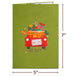 Green Christmas card cover with a red truck carrying gifts and a 'Dec. 25' license plate.