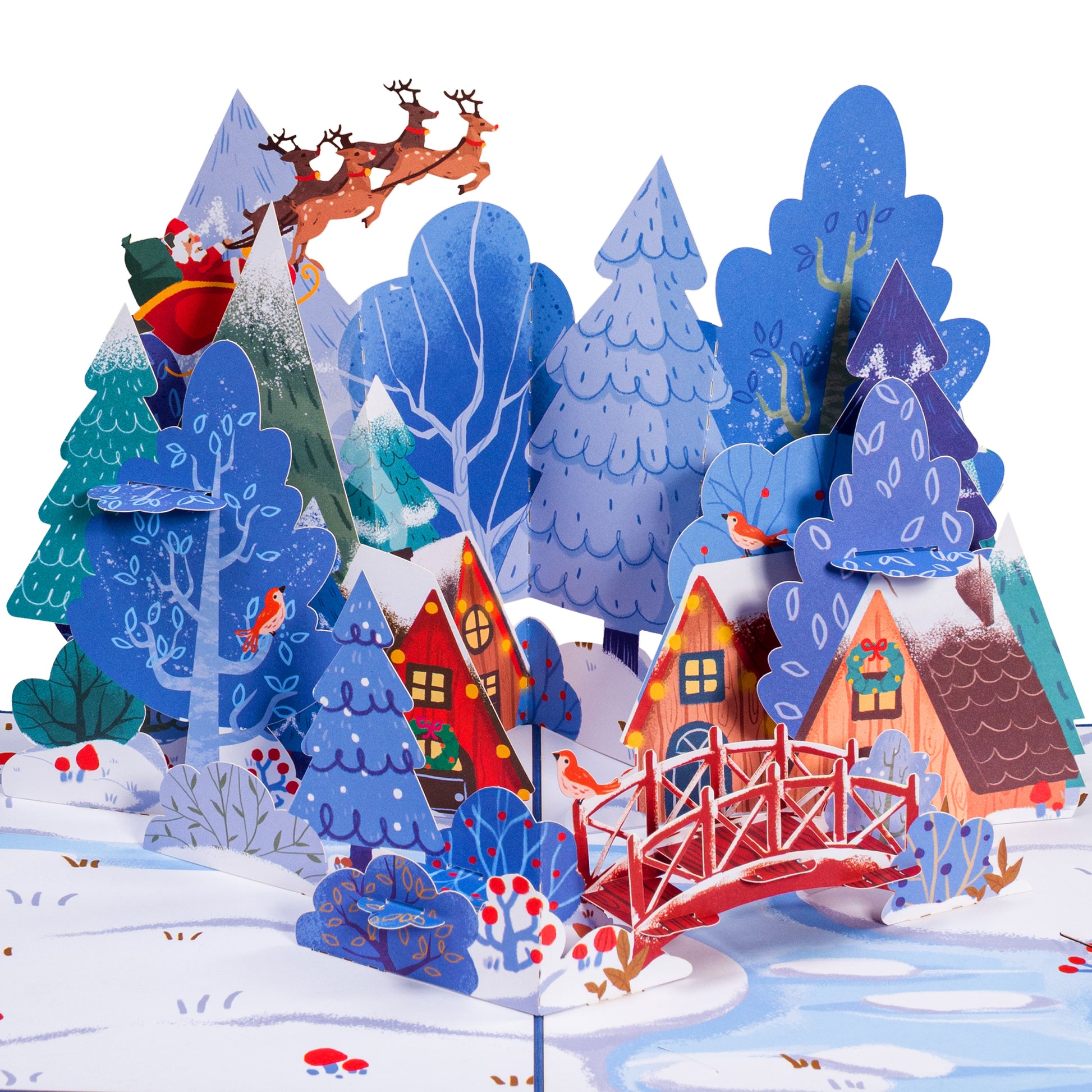 Close-up of the Magical Town Christmas pop-up card with snowy trees and a red bridge.