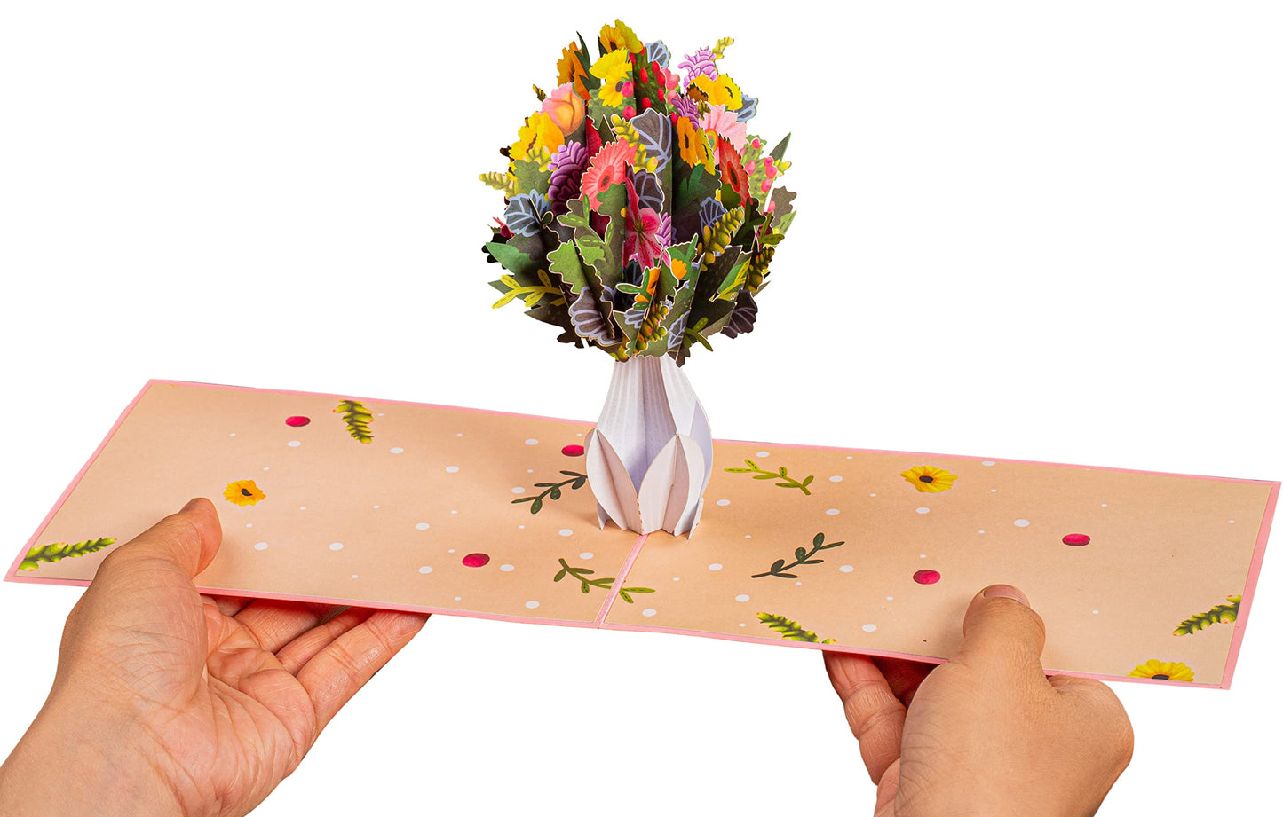 Hands holding a flower vase pop-up card with vibrant 3D flowers.