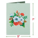 Front cover of Christmas card featuring floral design with red and white flowers.