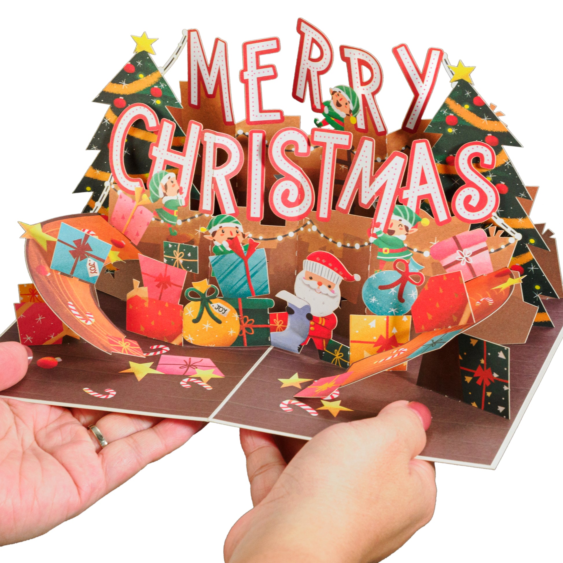 Hands holding a Merry Christmas pop-up card with vibrant holiday design.