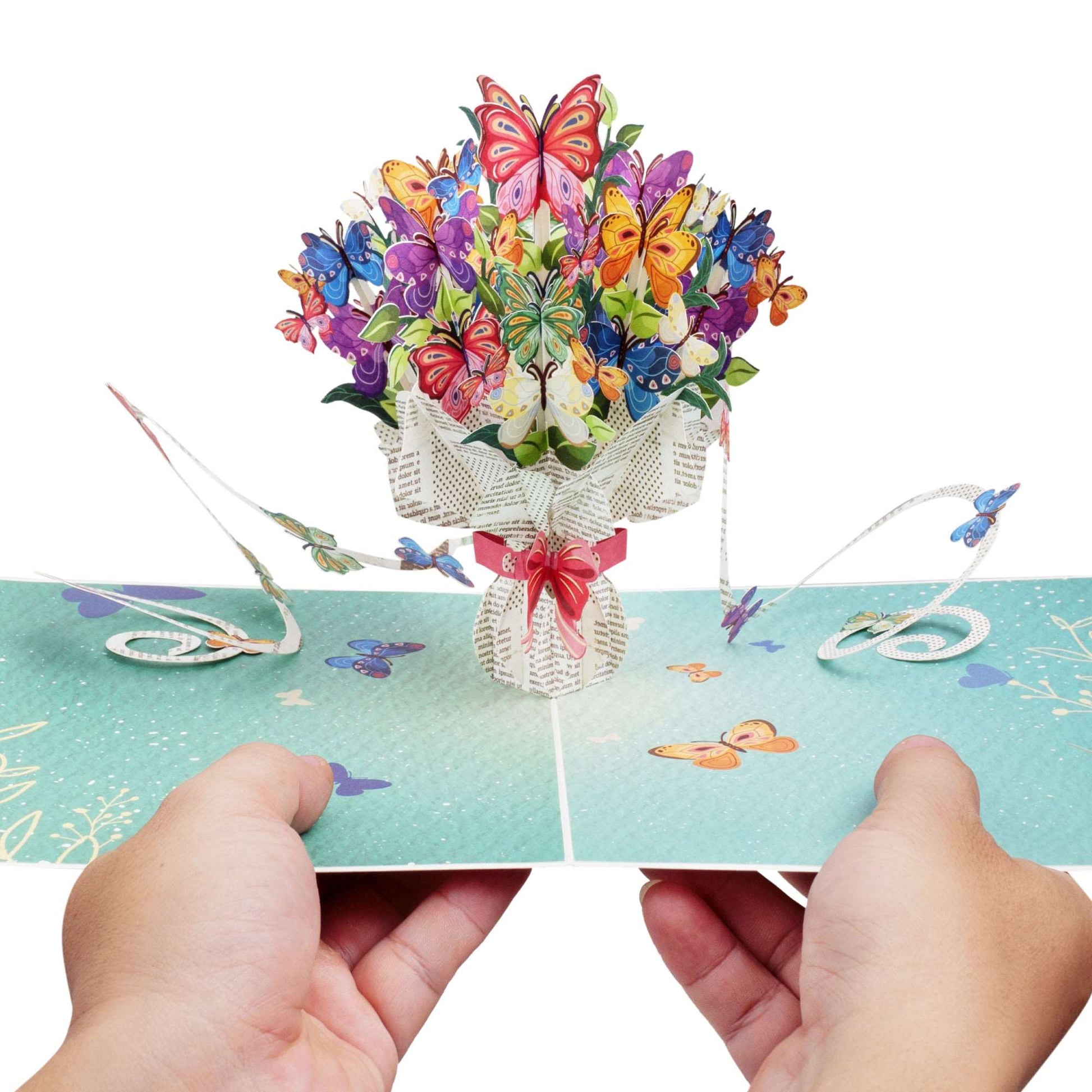 Hands opening Butterflies Bouquet Pop Up Card revealing 3D butterfly bouquet.