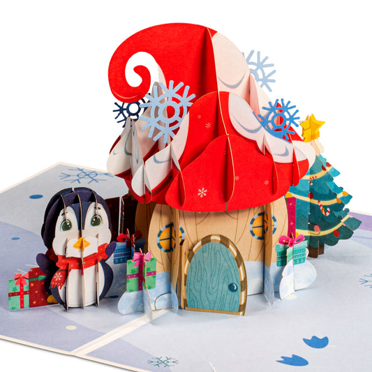 Pop-up Christmas card featuring a festive mushroom house with a penguin and gifts.