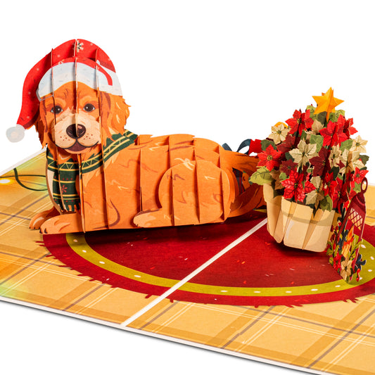 Christmas dog pop-up card featuring a festive dog in a Santa hat with a poinsettia basket.