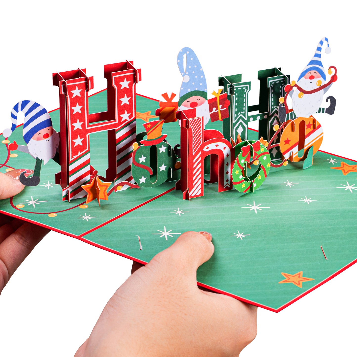 Hands holding a vibrant Ho Ho Ho Christmas popup card with 3D holiday design.