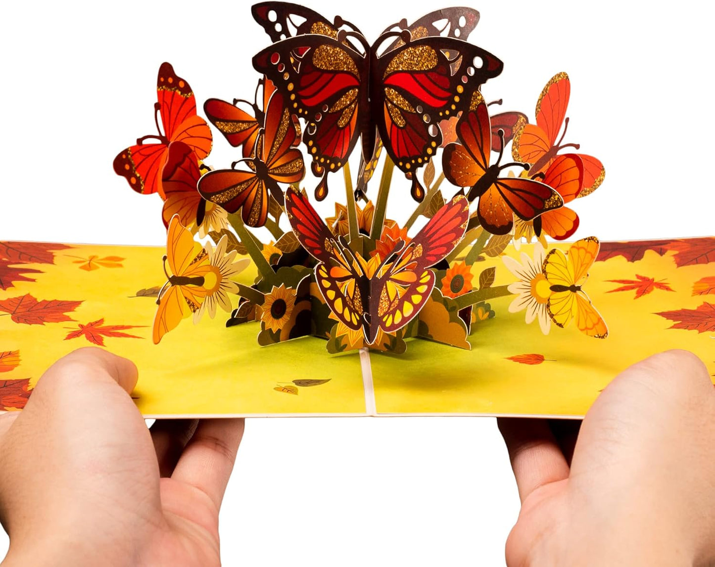 Hands holding the Fall Butterflies Pop Up Card with intricate butterfly details.