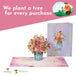 Pop-up card with flower bouquet and message about planting a tree for every purchase.