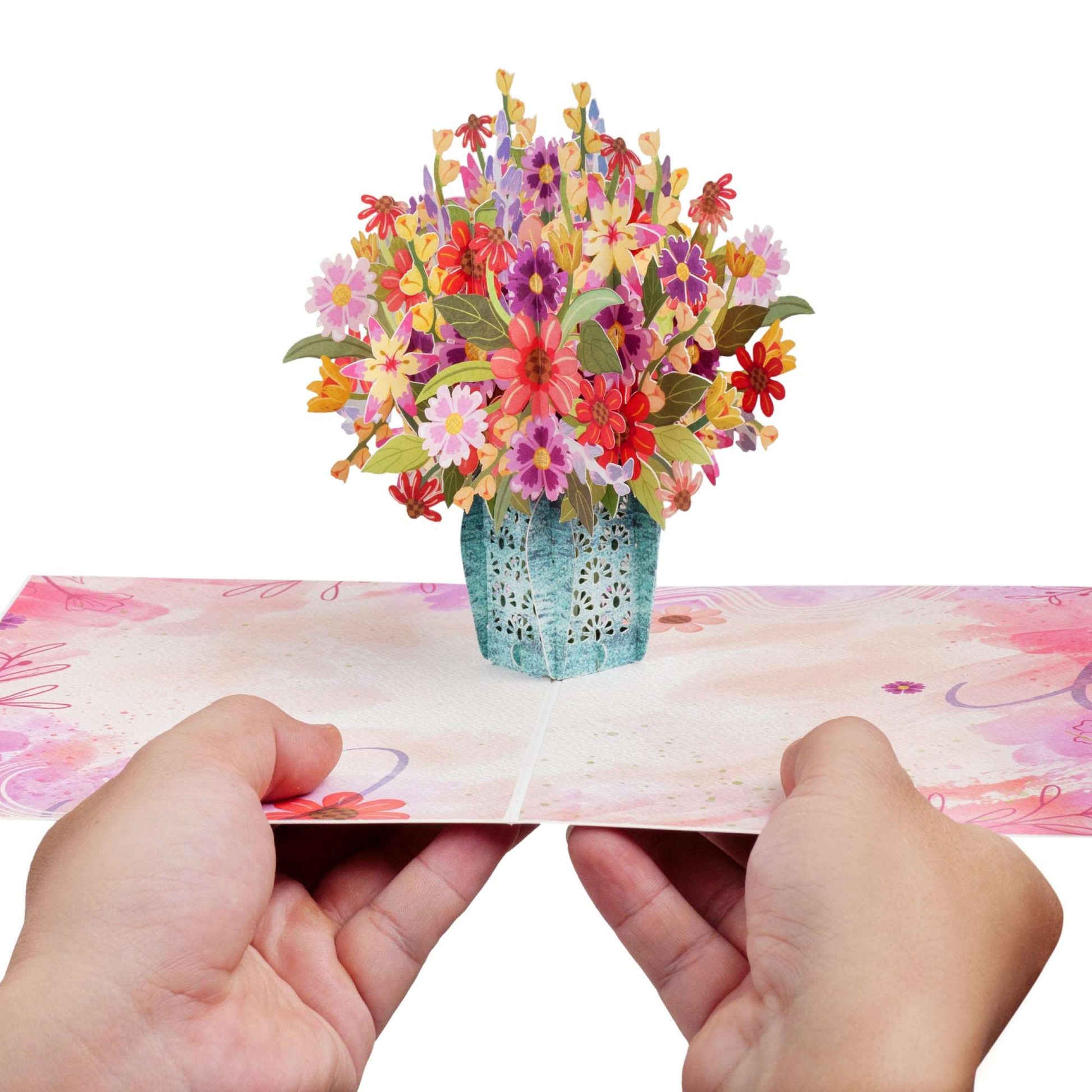 Hands holding the flower bouquet pop-up card, showcasing its 3D design.